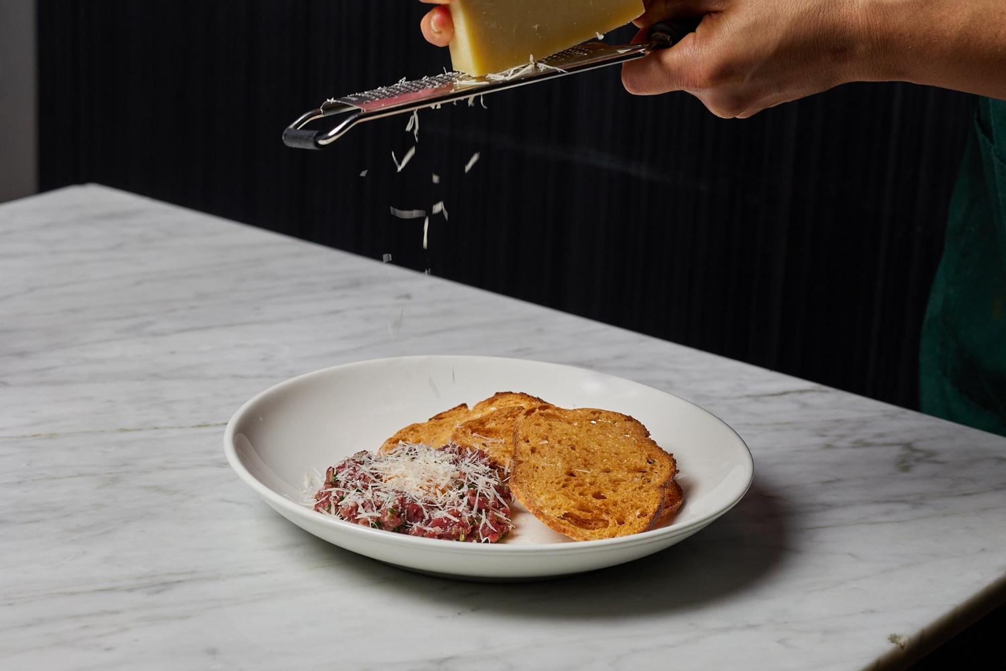 The Inchcolm By Ode Hotels Брисбен Экстерьер фото Parmigiano-Reggiano being grated over a dish of bread